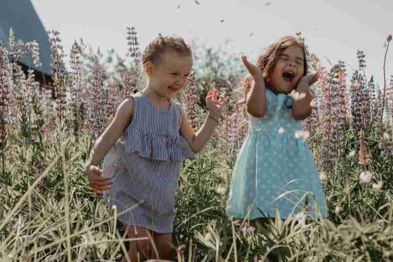 two girls in a field of flowers