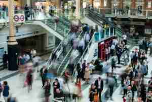 people standing and walking on stairs in mall