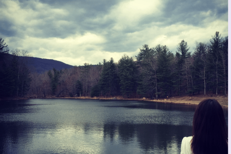 Grief-Getting to The Core With Peace-a woman standing in front of a lake