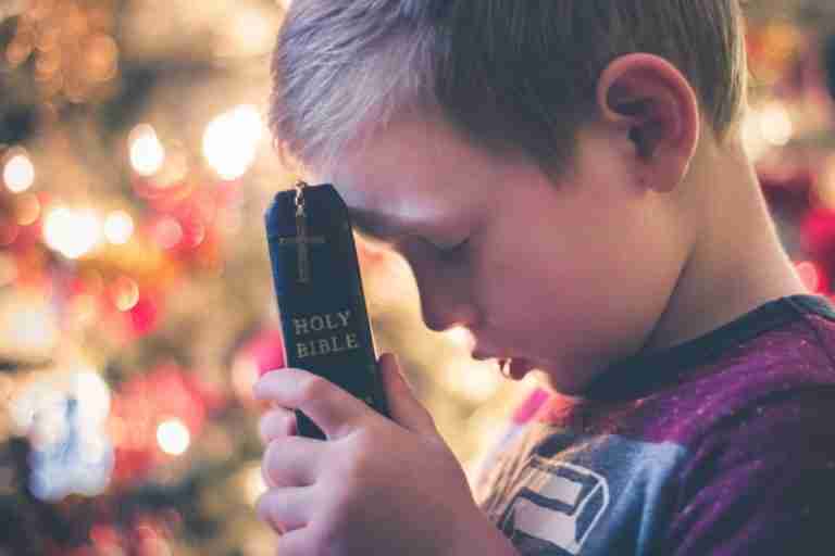 Pride Cometh Before The Fall-a boy holding a bible