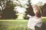 Life Lessons and Instructions From The Bible-a woman sitting on a rock reading a book