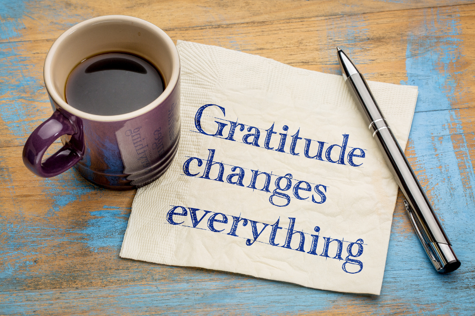 How Gratitude Can Change Your Life -a napkin with a cup of coffee and a pen on a wooden surface