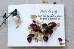 Why You Should Set Boundaries In Your Life- a notepad with dried flowers and a dried rose